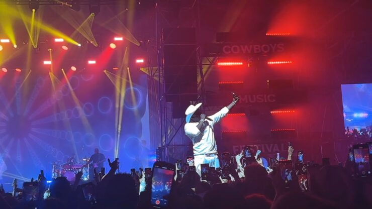 Crowds watch a live performance during a Calgary Stampede music festival concert