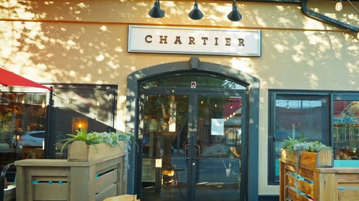 Entrance of Chartier restaurant in Beaumont with patio seating outside