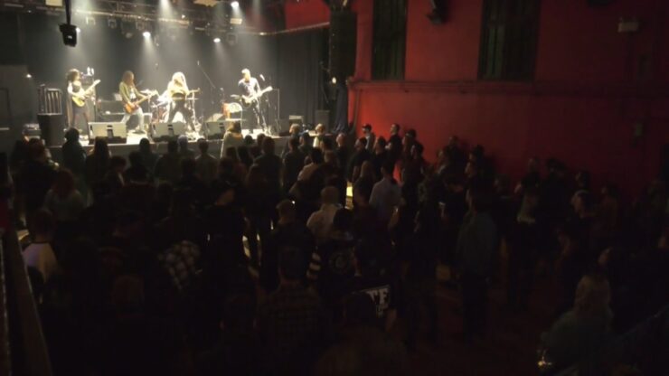 Crowd watching a live band perform on stage at a downtown Edmonton music venue