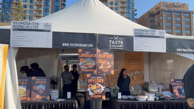 Food vendors serve festival dishes at a Taste of Calgary booth in downtown Calgary
